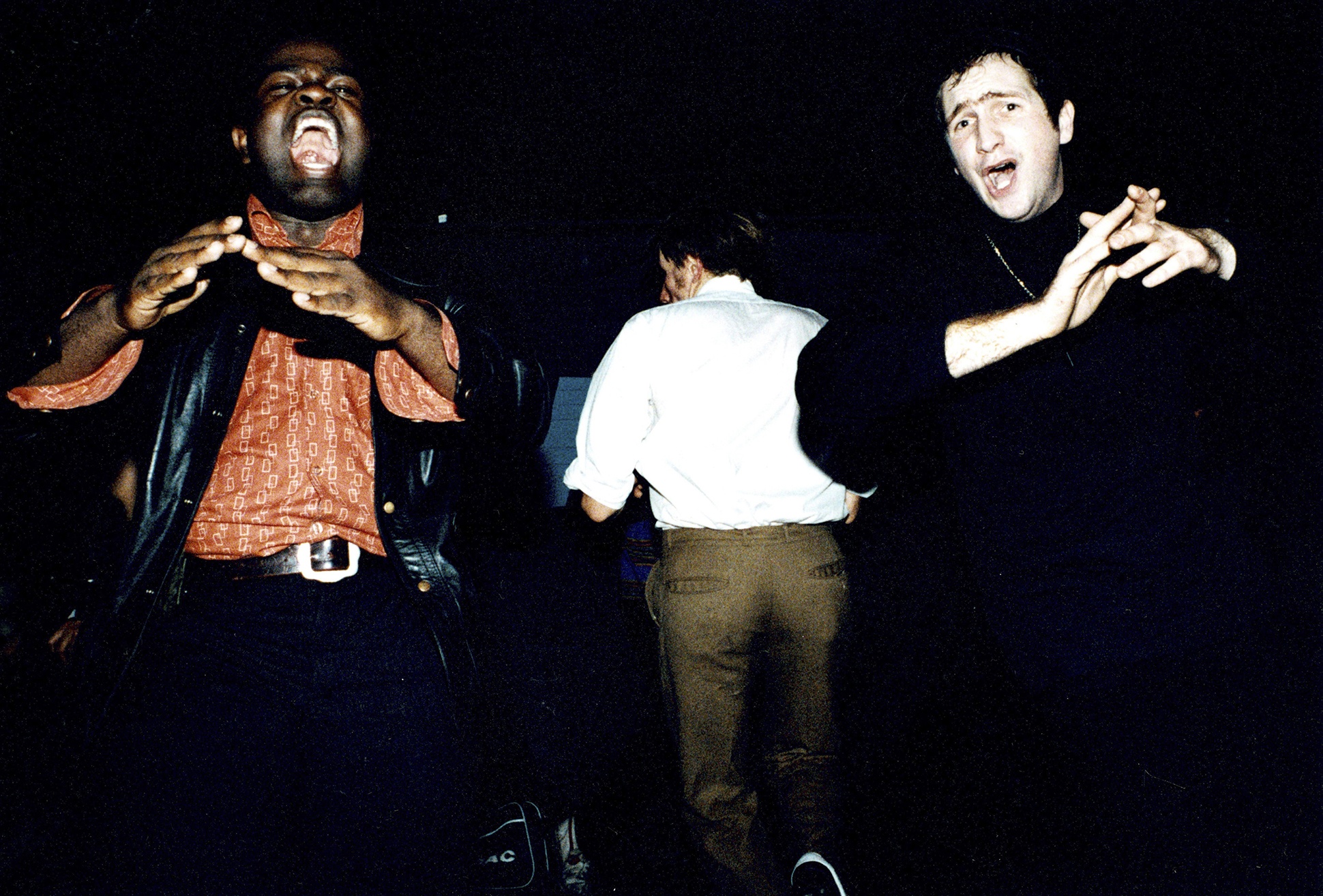 Two Northern Soul dancers clapping on the dance floor at an allnighter, London, 1990s by Rebecca Lewis