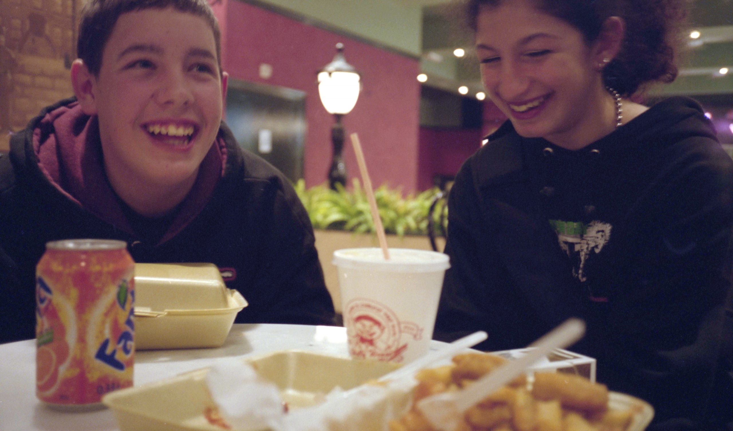 rebecca-lewis-fast-food Nu-metal teenagers having a laugh in a fast food restaurant, Liverpool, UK, 2001 by Rebecca Lewis