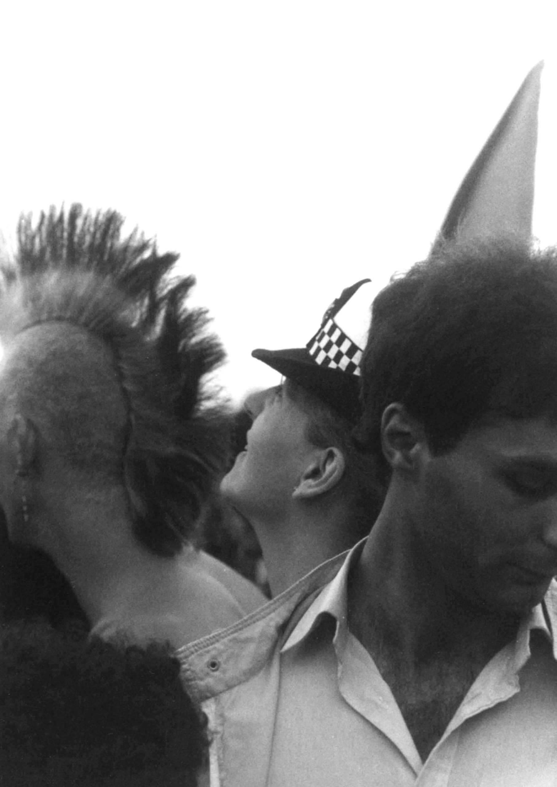 Three men at a protest for nuclear disarmament Three men at a protest for nuclear disarmament including a man with a mohawk and a policeman, UK, 1980s.