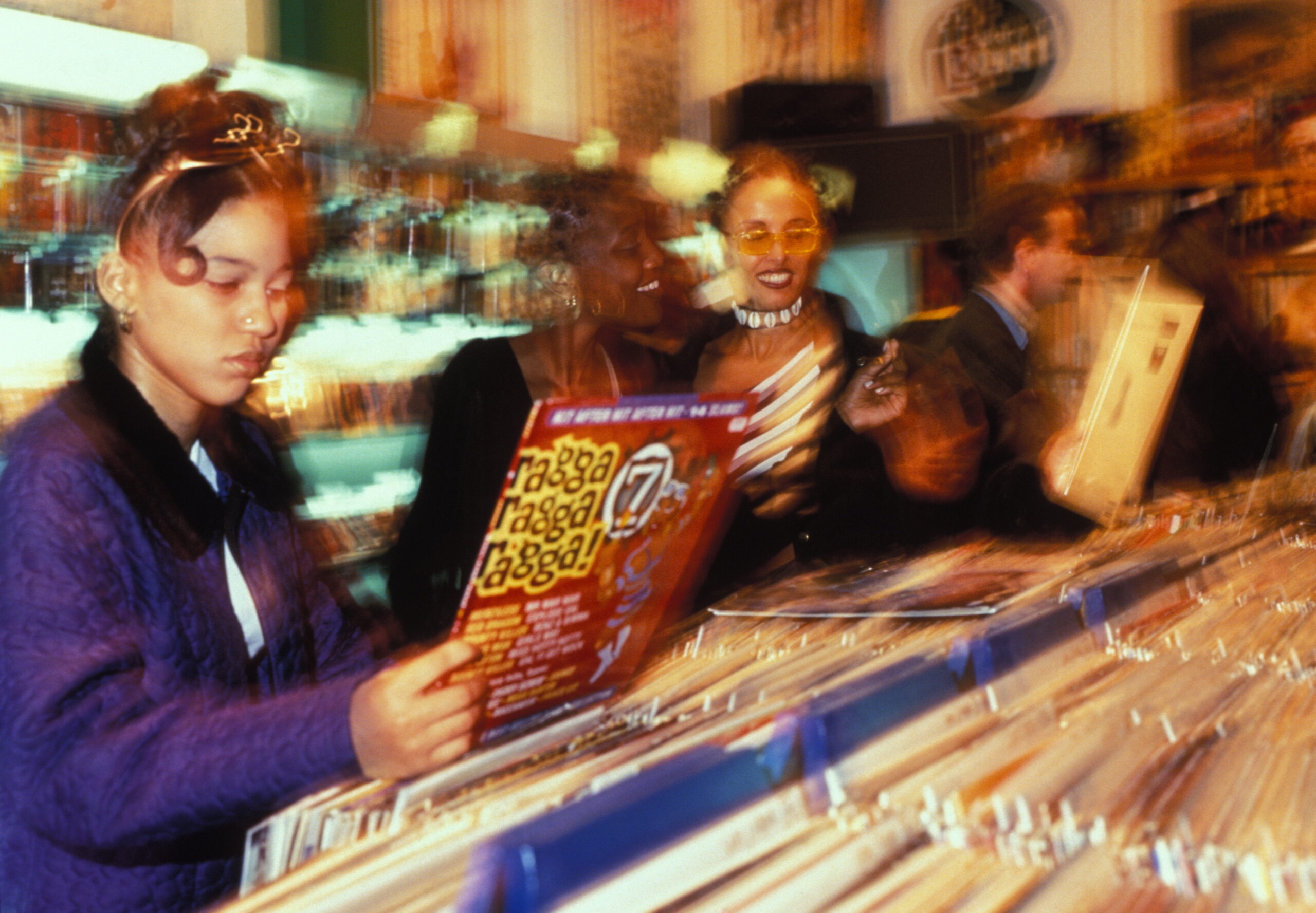 A group of girls looking at Ragga records, record shop, London, U.K 1990's. A group of girls looking at Ragga records, record shop, London, U.K 1990's.